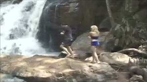 couple Rests By A Waterfall
